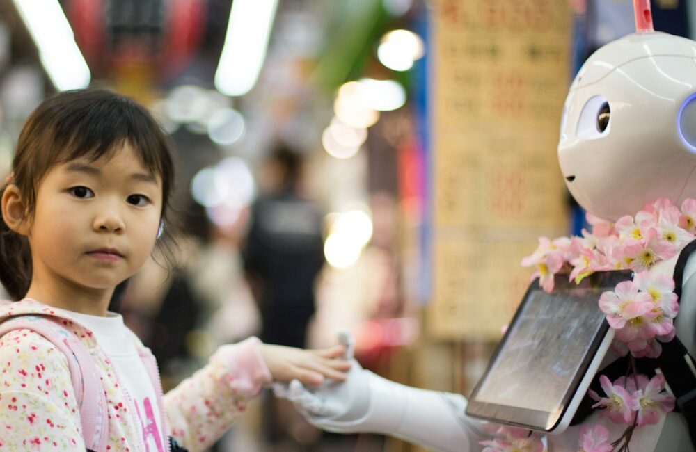 photo of girl laying left hand on white digital robot