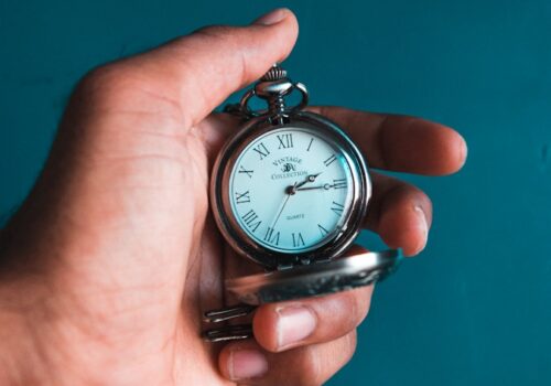 person holding pocket watch