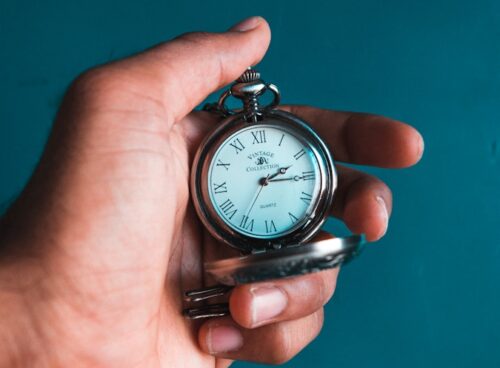 person holding pocket watch