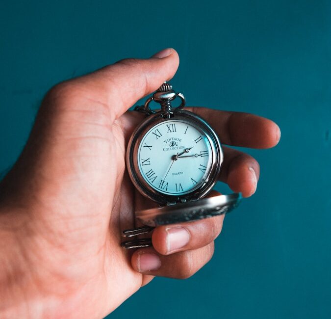 person holding pocket watch