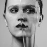 a woman's face is shown through a broken glass
