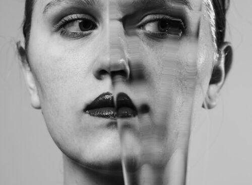 a woman's face is shown through a broken glass