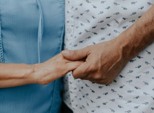 person in blue shirt and white and black pants