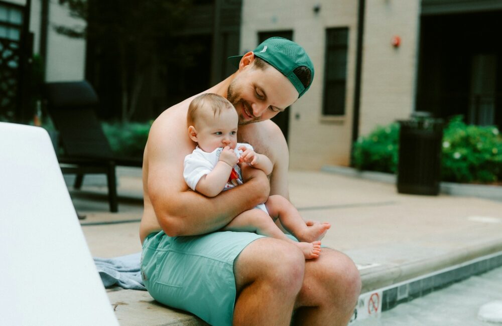 Father and baby enjoy some poolside time.