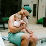 Father and baby enjoy some poolside time.