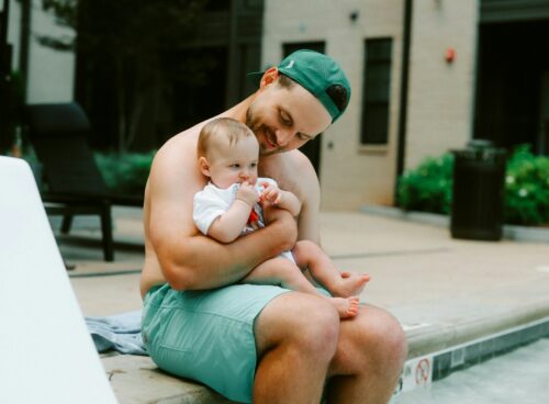 Father and baby enjoy some poolside time.