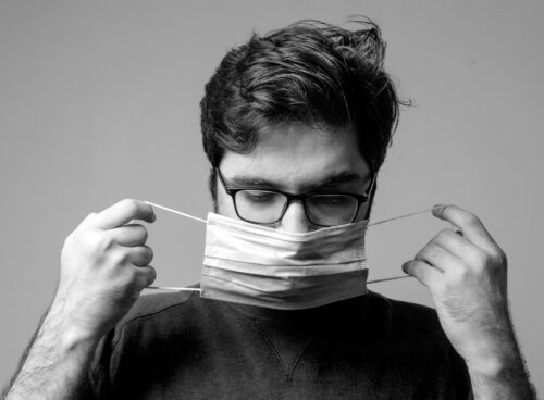 man in black crew neck shirt holding white paper