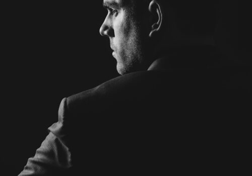 grayscale photo of man wearing blazer