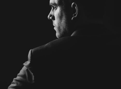 grayscale photo of man wearing blazer