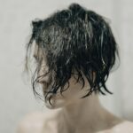 topless woman with black hair