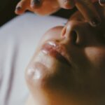 a woman getting a facial massage on her face
