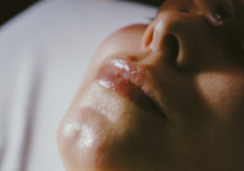 a woman getting a facial massage on her face