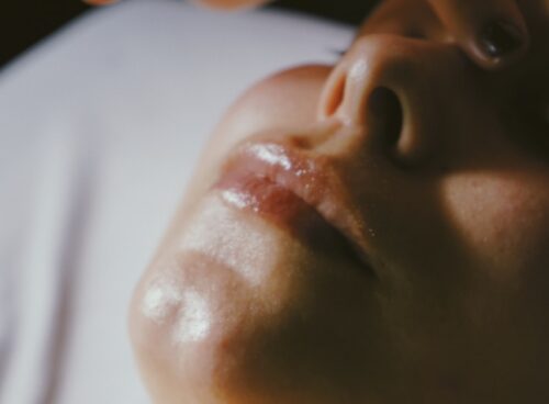 a woman getting a facial massage on her face