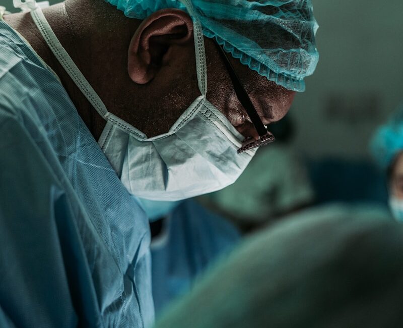 man wearing medical mask and robe