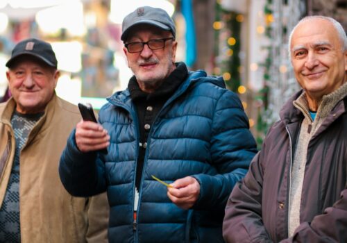 a group of three men standing next to each other