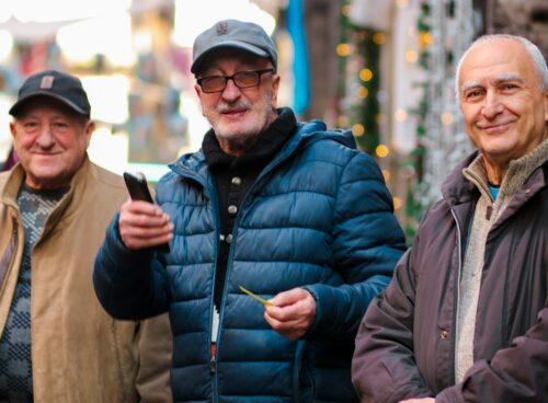 a group of three men standing next to each other