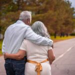 couple kissing on the road during daytime