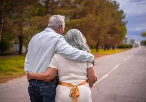 couple kissing on the road during daytime