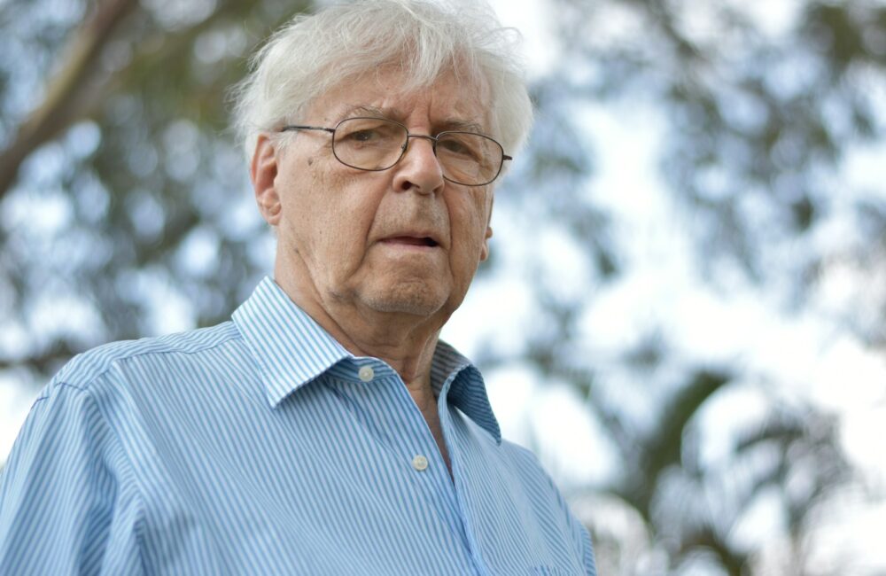 selective focus photography of man wearing blue and white striped collared top