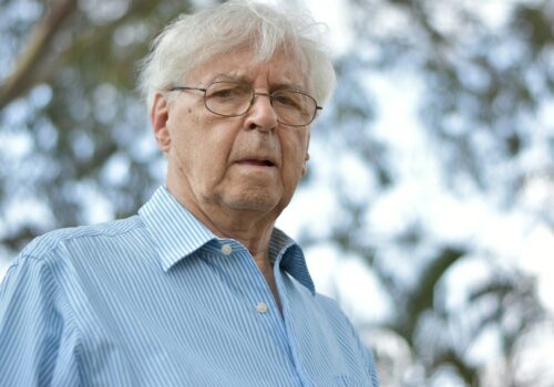 selective focus photography of man wearing blue and white striped collared top