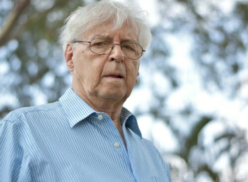 selective focus photography of man wearing blue and white striped collared top