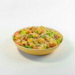 A bowl of food on a white surface