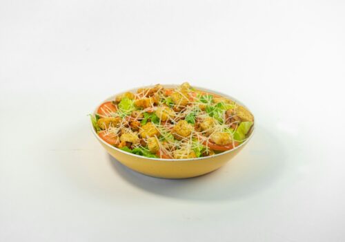 A bowl of food on a white surface