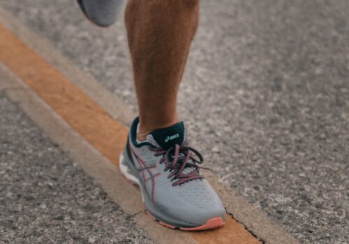 person in white nike sneakers