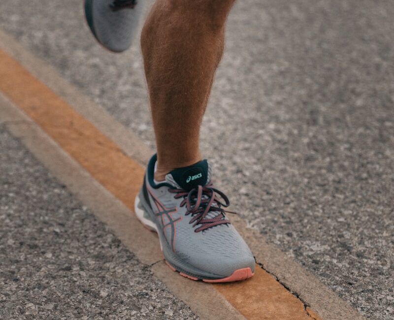 person in white nike sneakers