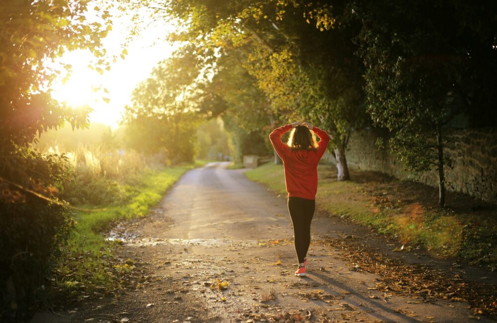 woman walking on pathway during daytime