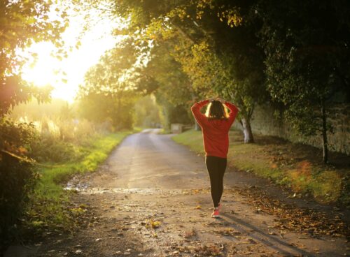 woman walking on pathway during daytime